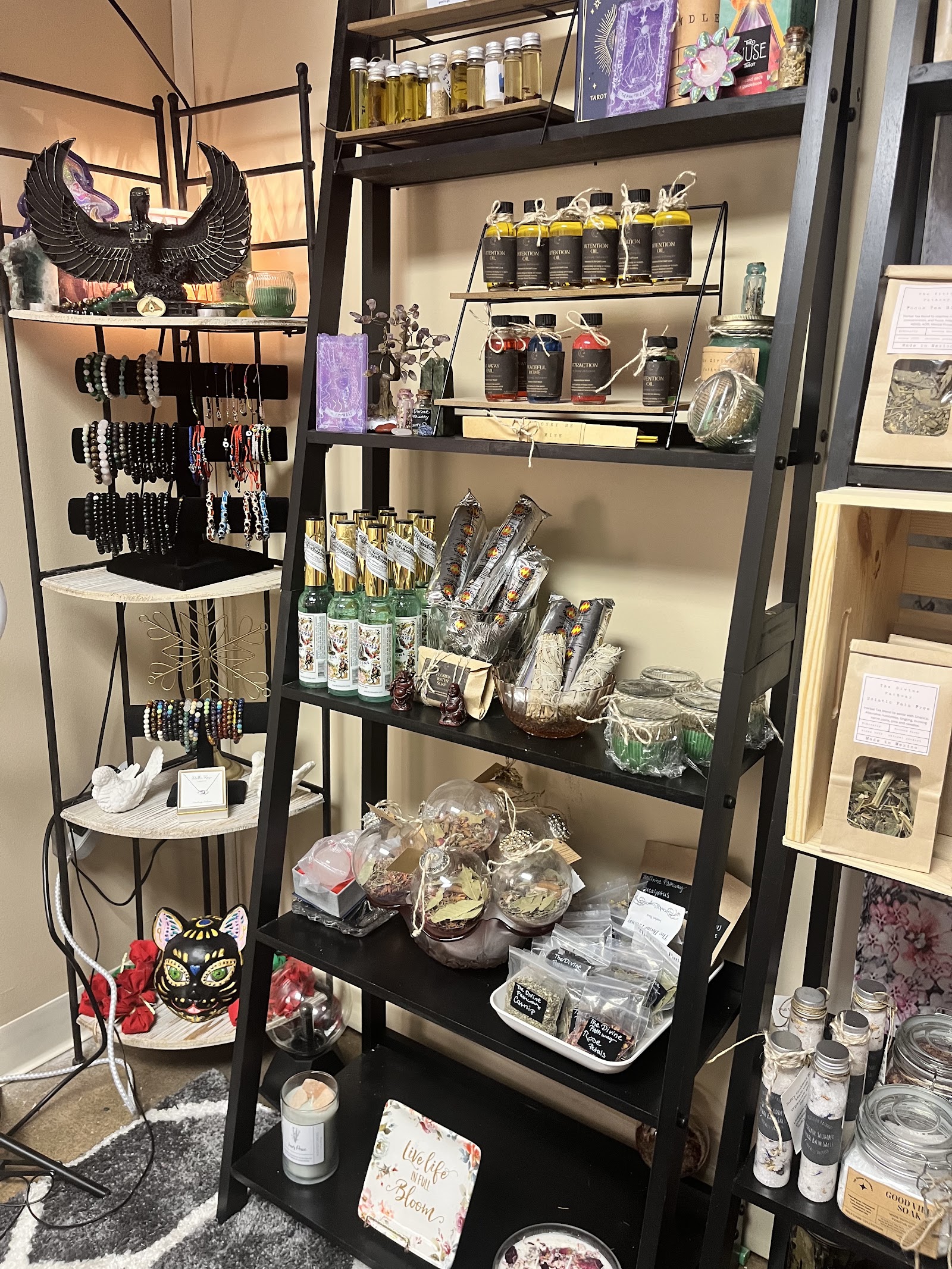 Metaphysical shop shelves at Psychic Readings by Michael — intention oils, candles, crystals, bracelets and sage